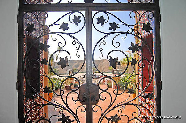 LLLL - Int. Mansion Ð  Iron Door Detail - Day